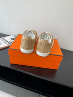 Hermes ladies sneakers rear view in tan suede with white laces