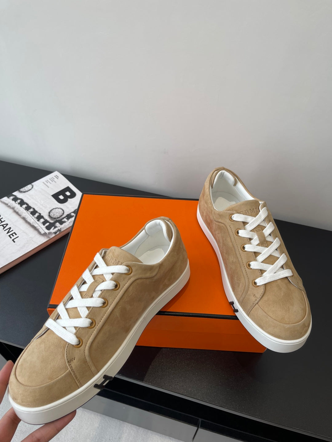 Hermes ladies low-top sneakers, tan suede, front quarter view with white laces