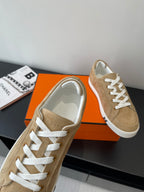 Hermes tan suede sneakers close-up of white lace-up and toe cap