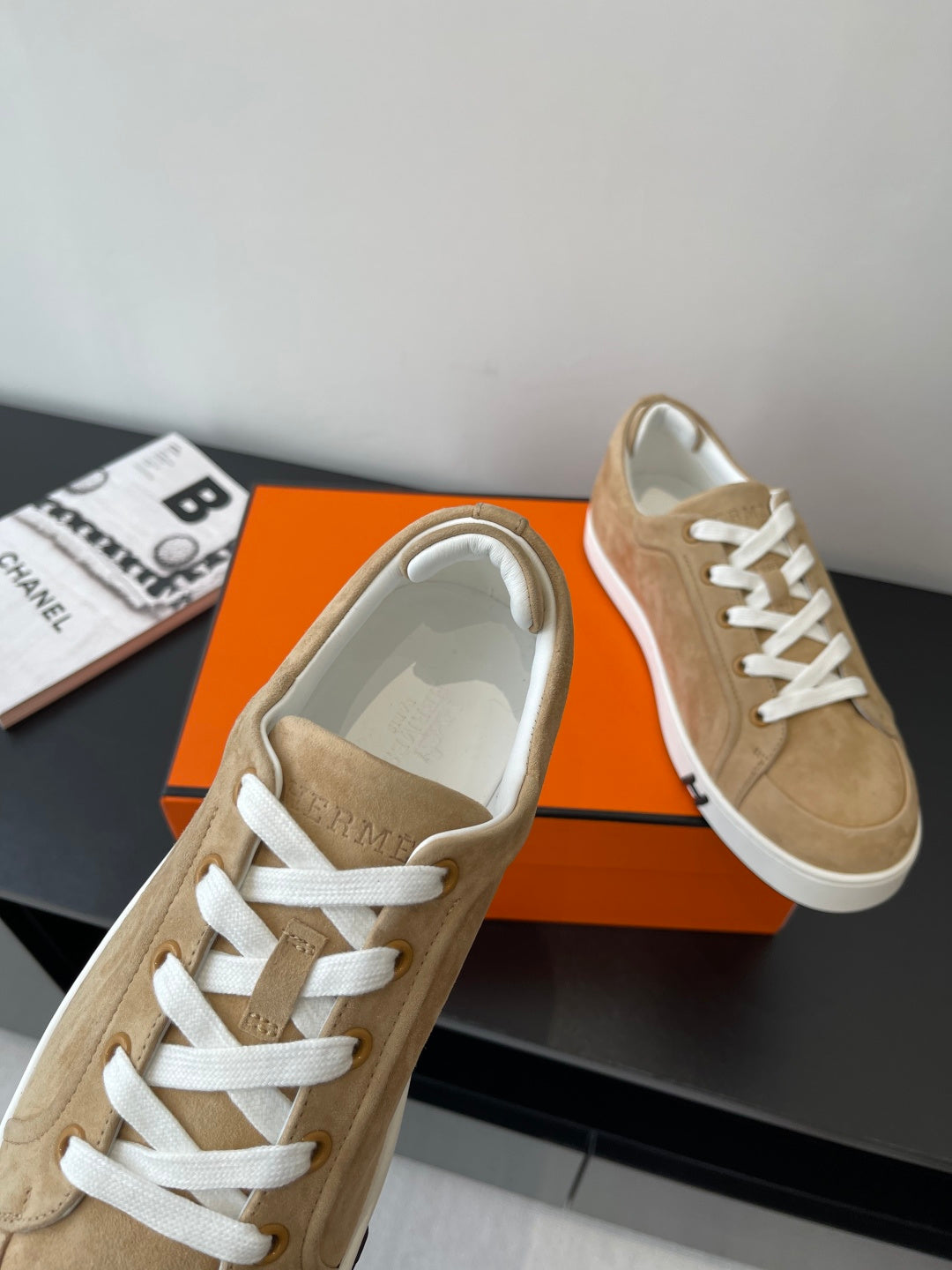 Hermes tan suede sneakers close-up of white lace-up and toe cap