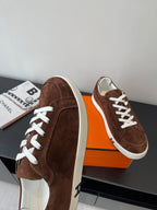 Brown suede low-top sneakers with white laces and white shell toe
