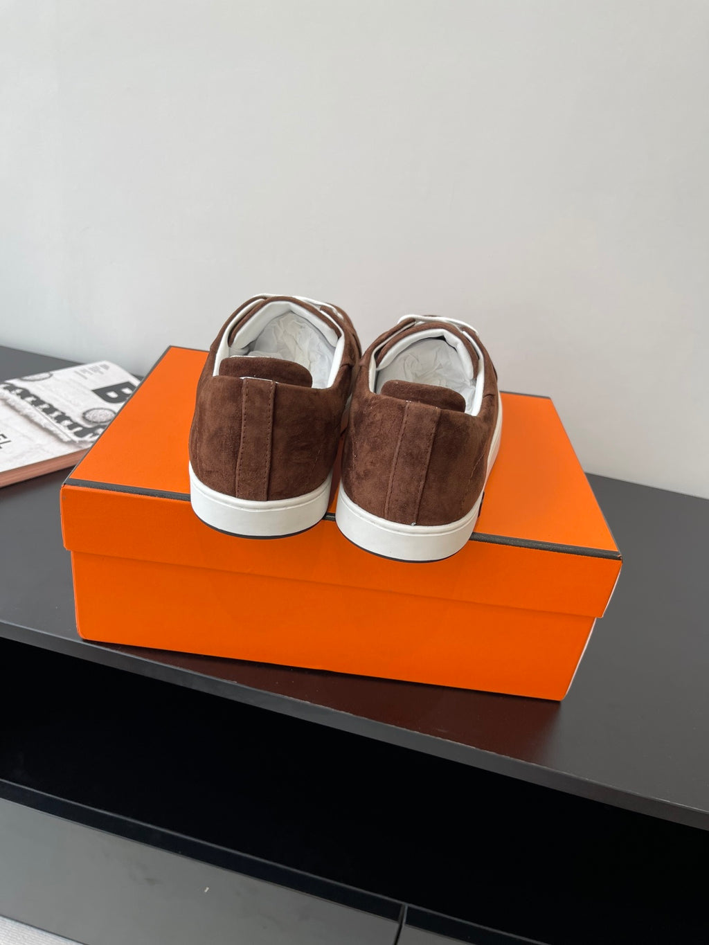 Brown suede low-top sneakers with white laces and white rubber heel