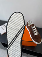 Brown suede sneakers with white ridged rubber outsole