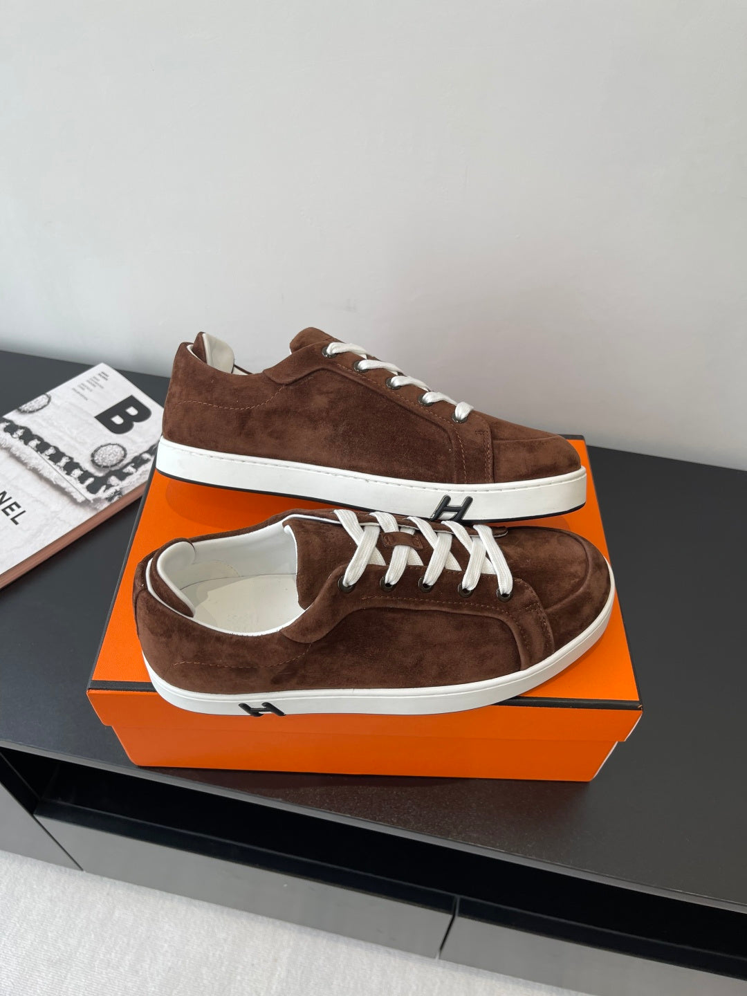 Brown suede low-top sneakers with white laces and white stripe midsole
