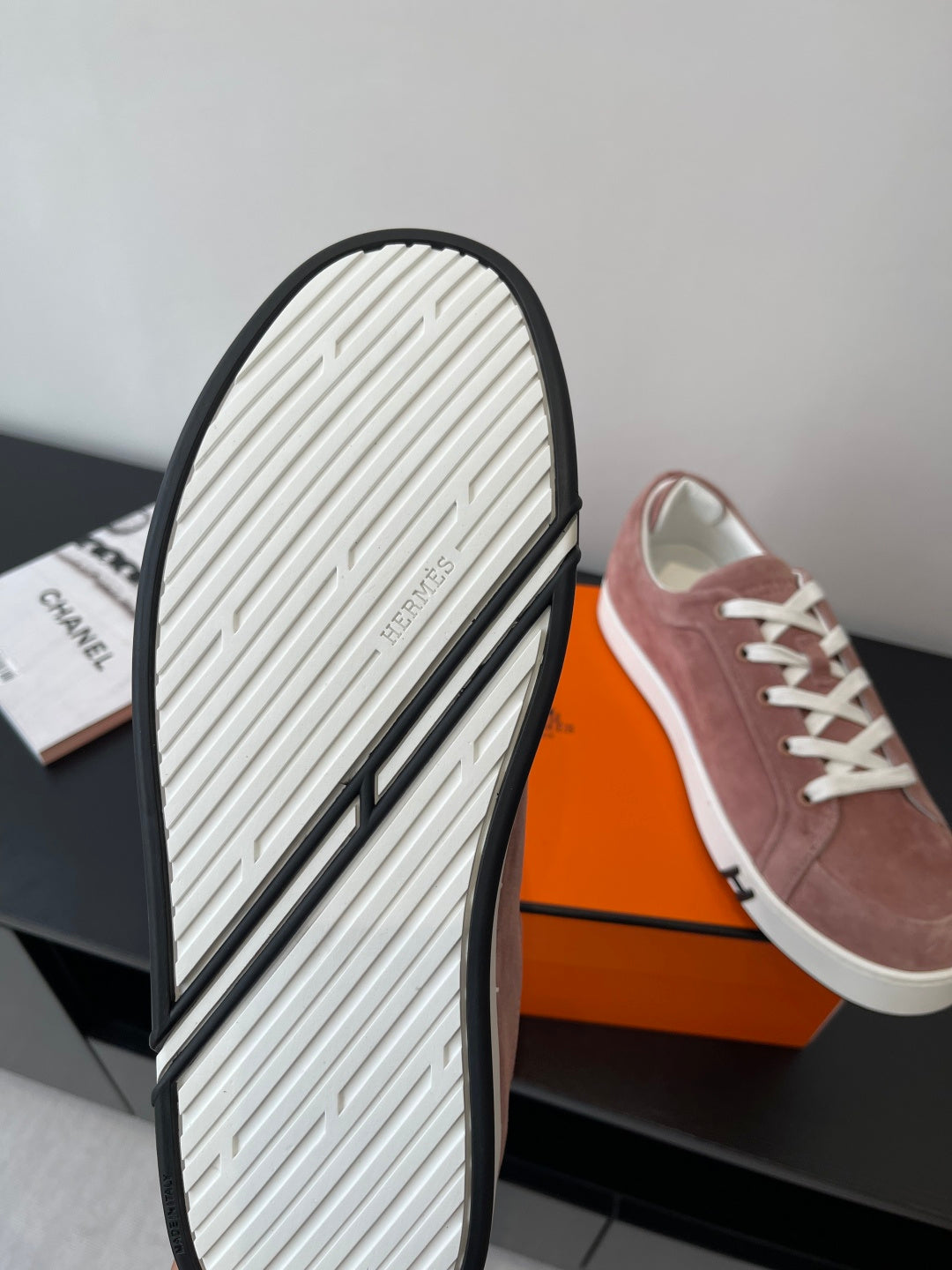 Hermes ladies sneaker outsole view with ribbed tread and white rubber base