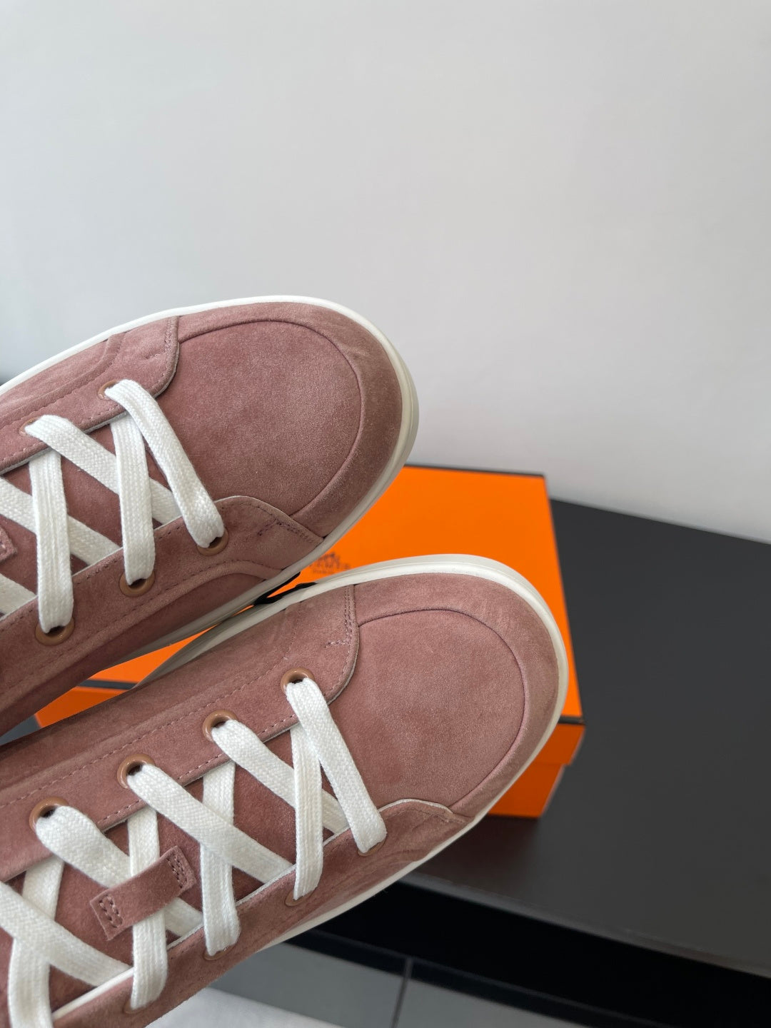 Hermes ladies suede sneakers close-up, dusty rose toe with white lace eyelets