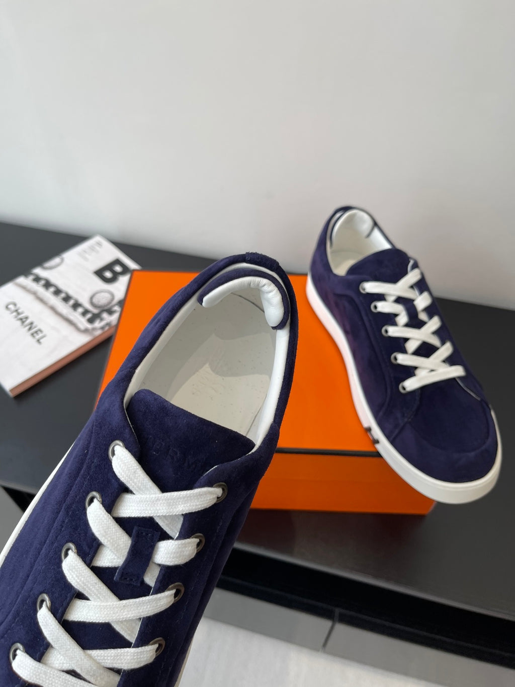 Hermes women's navy suede sneakers, one toe and interior lining visible, lace-up front