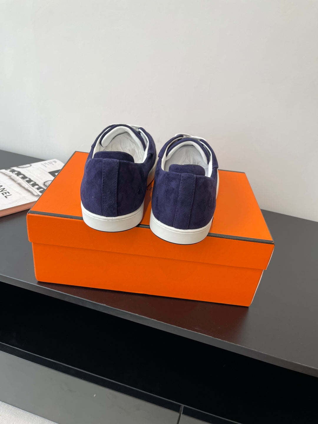 Hermes women's navy suede sneakers with white laces and white soles, heel and back view