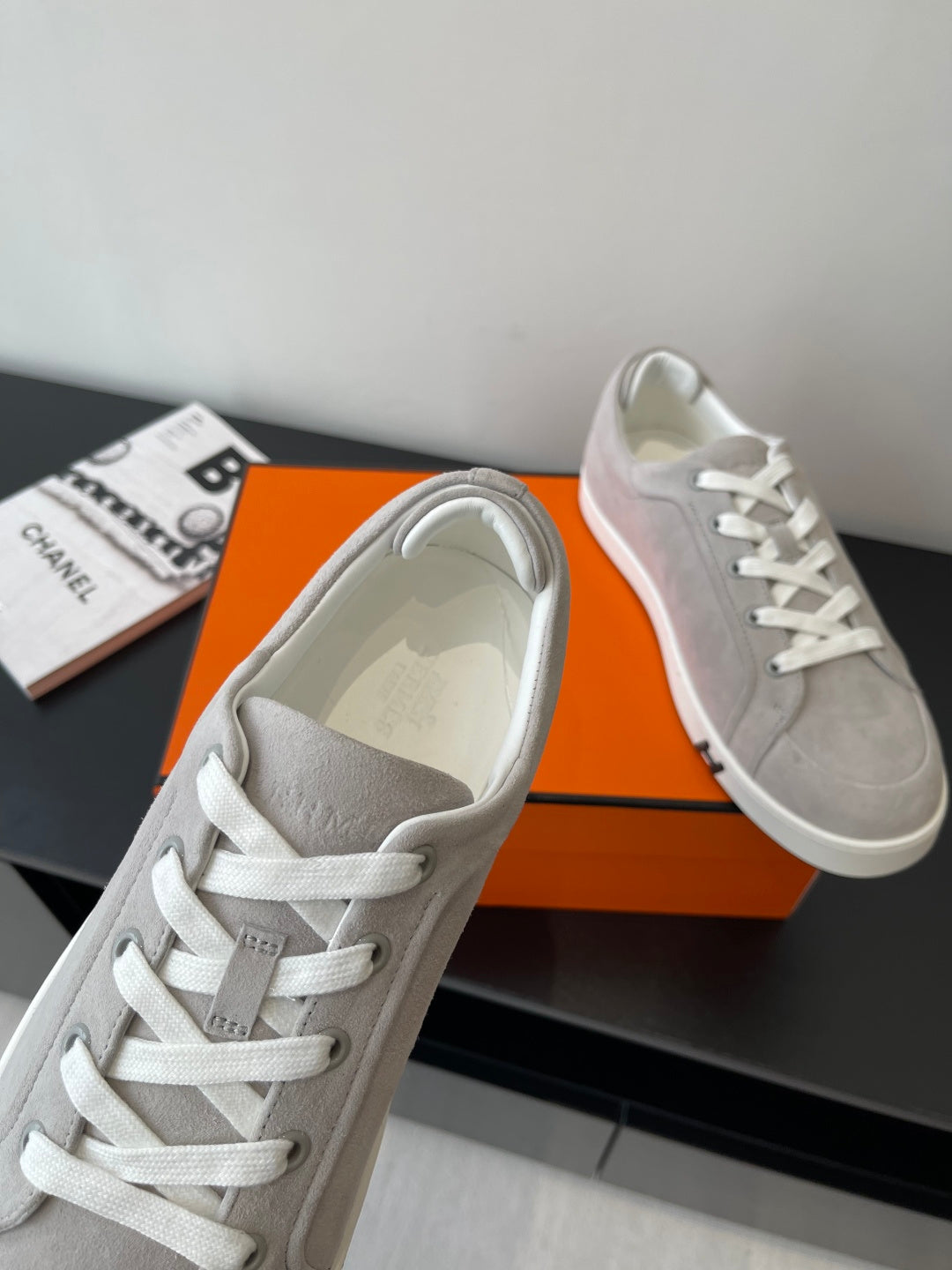 Hermes ladies sneakers close-up: light gray upper with white lace and strap detail