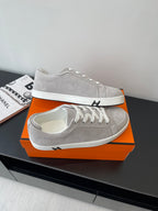 Hermes ladies sneakers on orange box, light gray with white laces and white sole