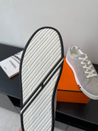 Hermes ladies sneaker sole view, light gray sidewall with black trim