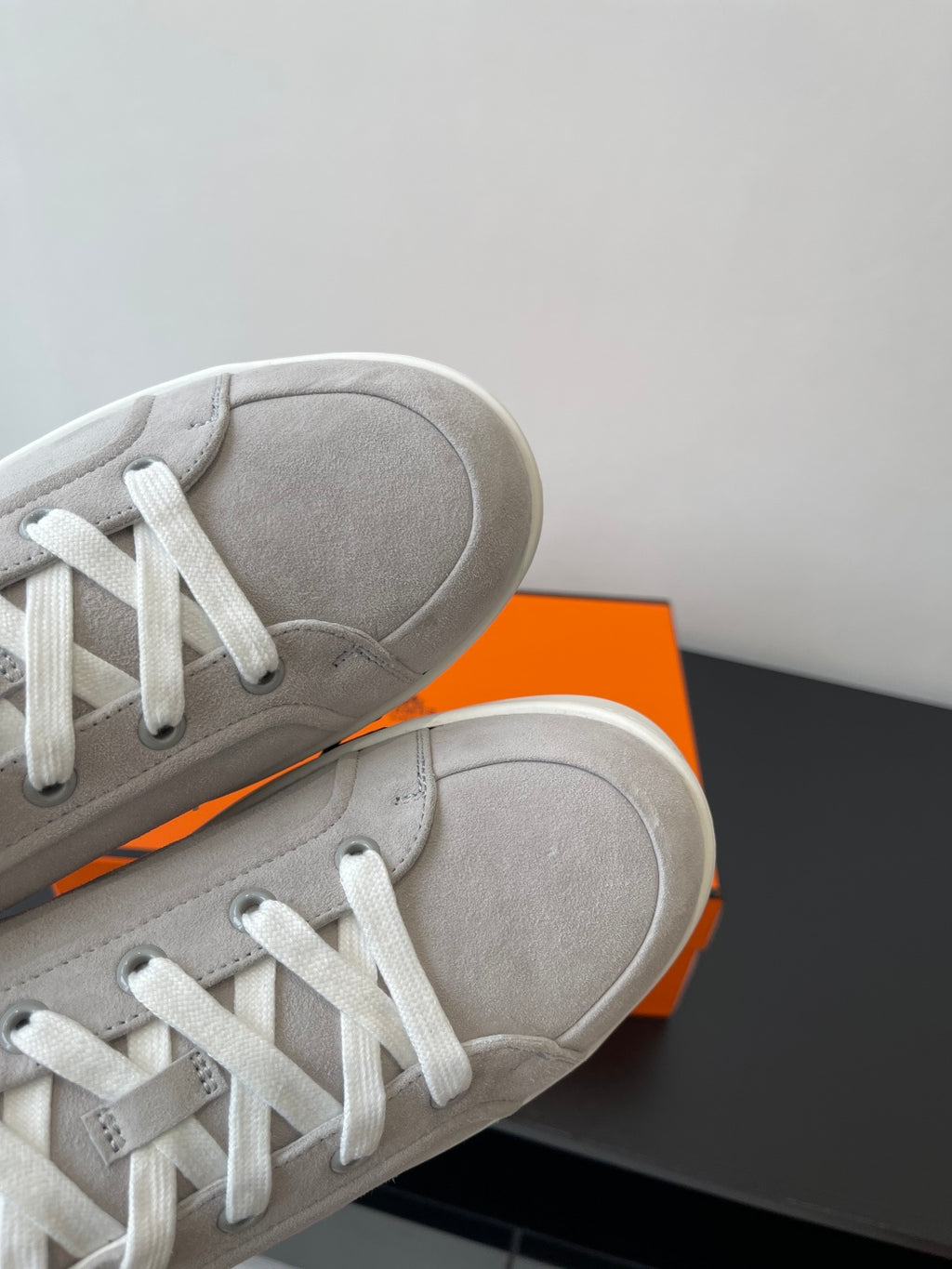 Hermes ladies sneakers close-up of light gray upper and white lace