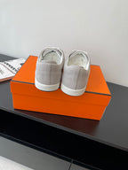 Hermes ladies sneakers back view, light gray uppers with white laces