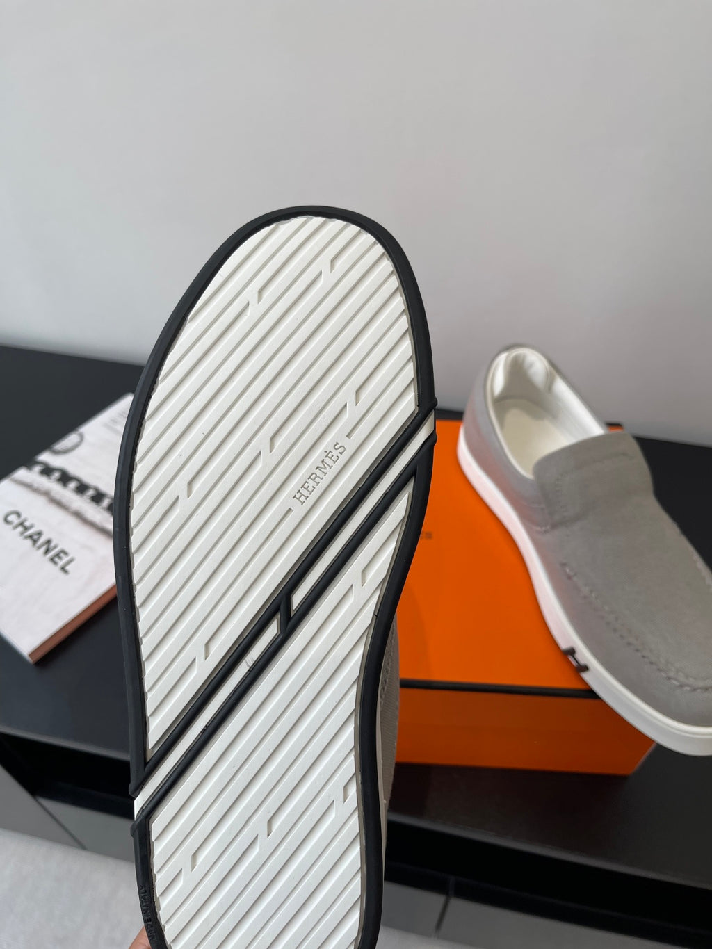 Hermes slip-on sneakers outsole view, white tread with dark edge trim