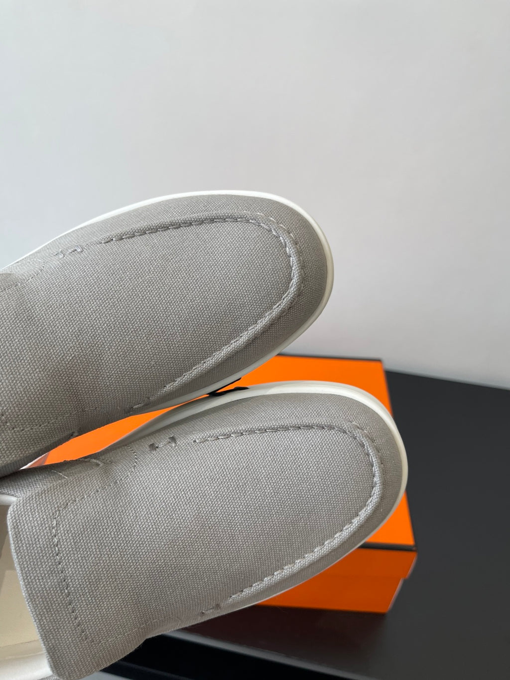 Hermes slip-on sneakers, close-up of light gray canvas toe and side stitching