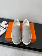 Hermes slip-on sneakers in light gray canvas, rounded toe, stitched side panels