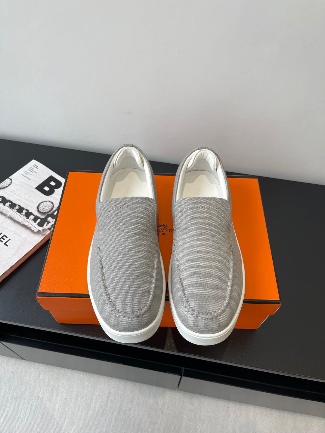 Hermes slip-on sneakers in light gray canvas, rounded toe, stitched side panels