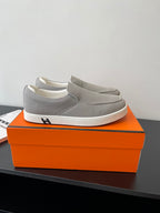 Hermes low-top slip-on sneakers, light gray fabric upper with white rubber sole