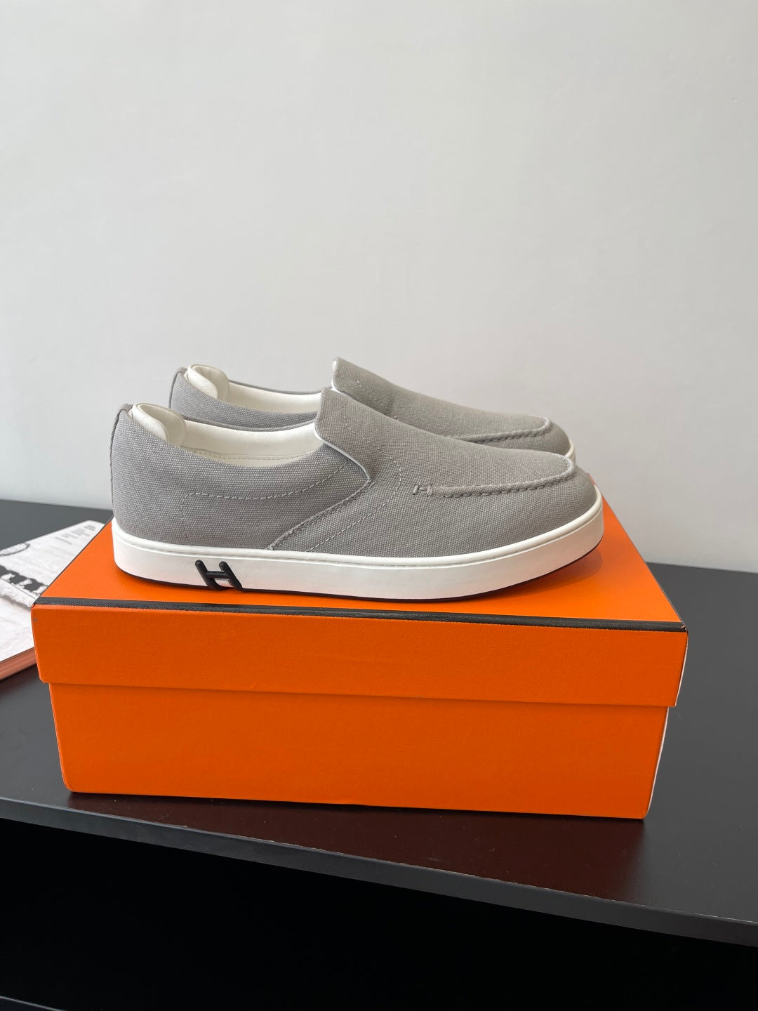 Hermes low-top slip-on sneakers, light gray fabric upper with white rubber sole