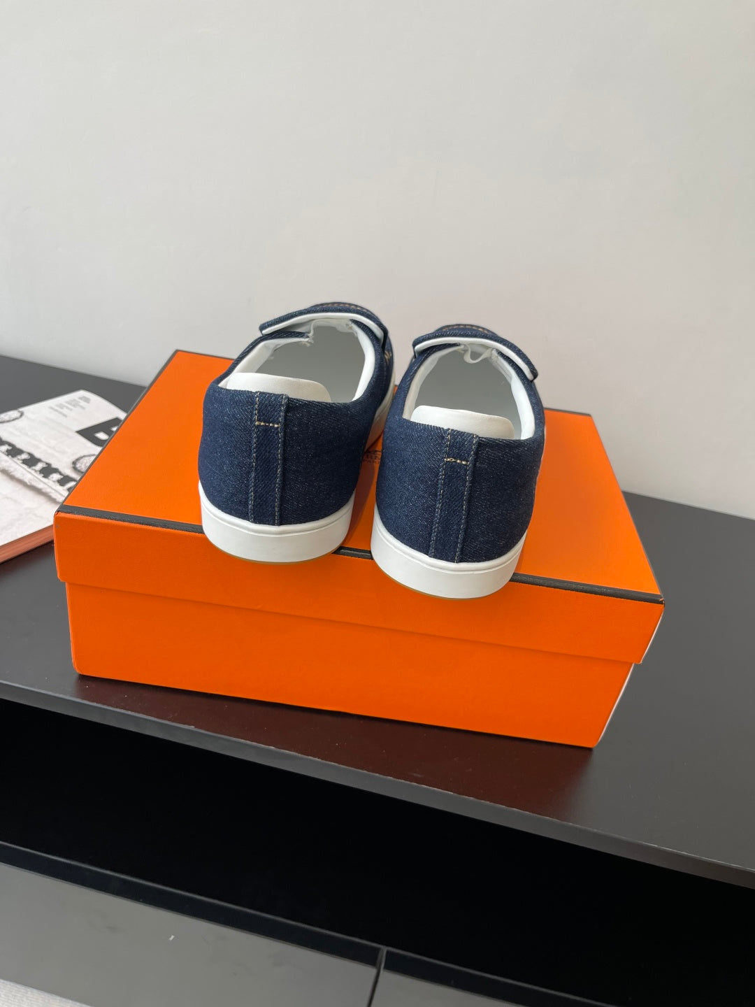 Hermes women's navy denim slip-on sneakers, heel view with white sole