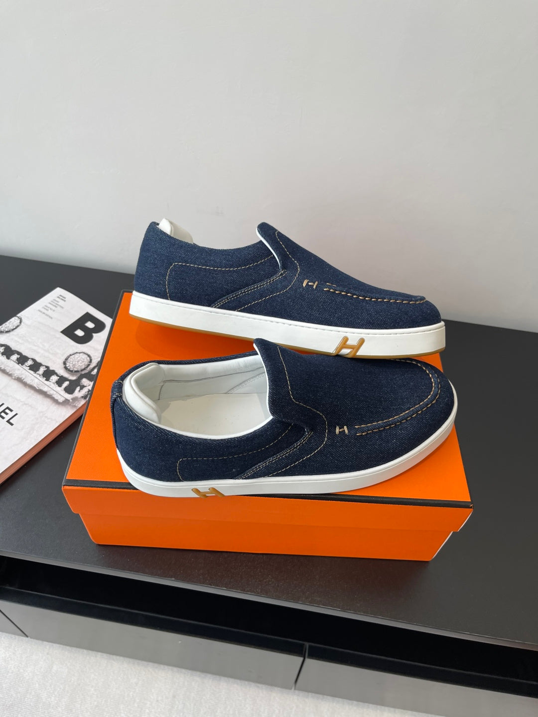 Hermes women's navy denim slip-on sneakers with white sole, top view