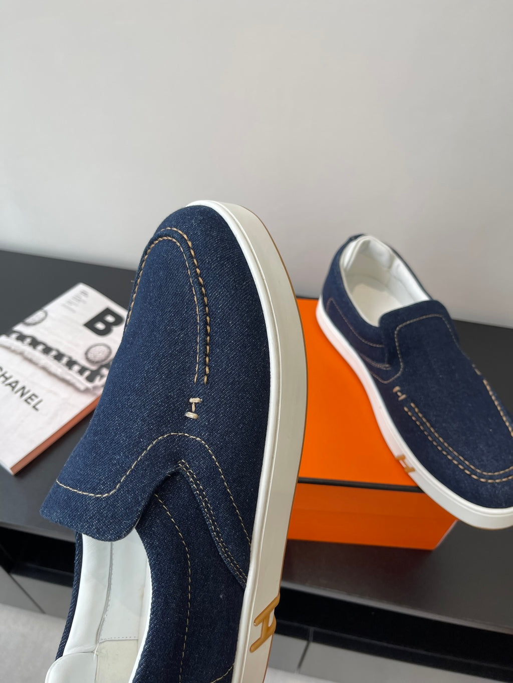 Hermes women's navy denim slip-on sneakers, side profile with small logo detail