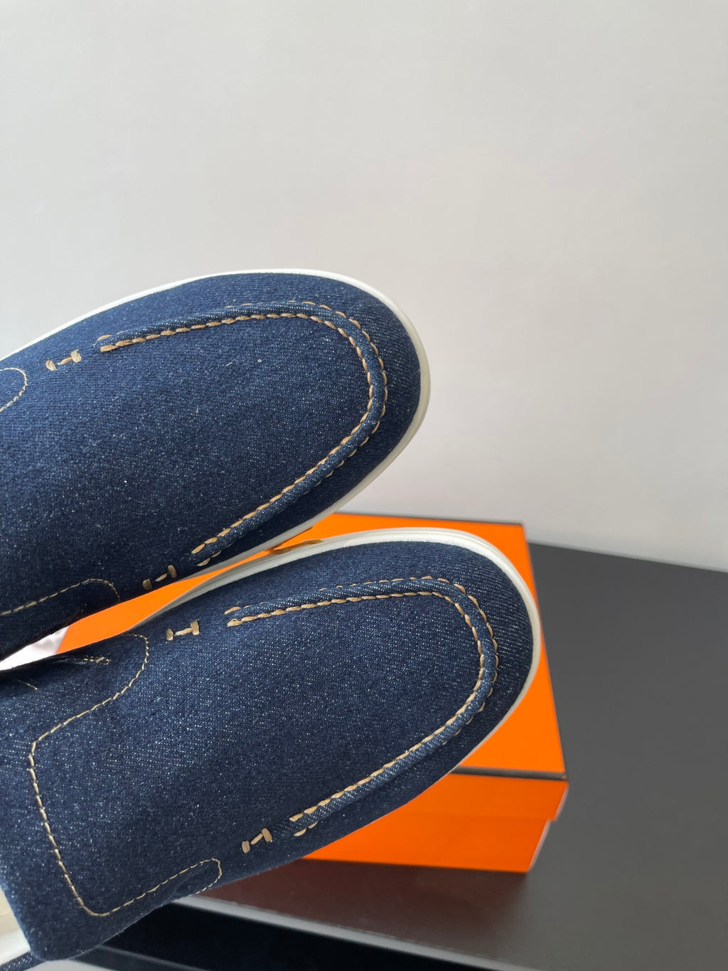 Hermes women's navy denim slip-on sneaker close-up, contrast stitched trim