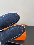 Hermes women's navy denim slip-on sneaker close-up, contrast stitched trim