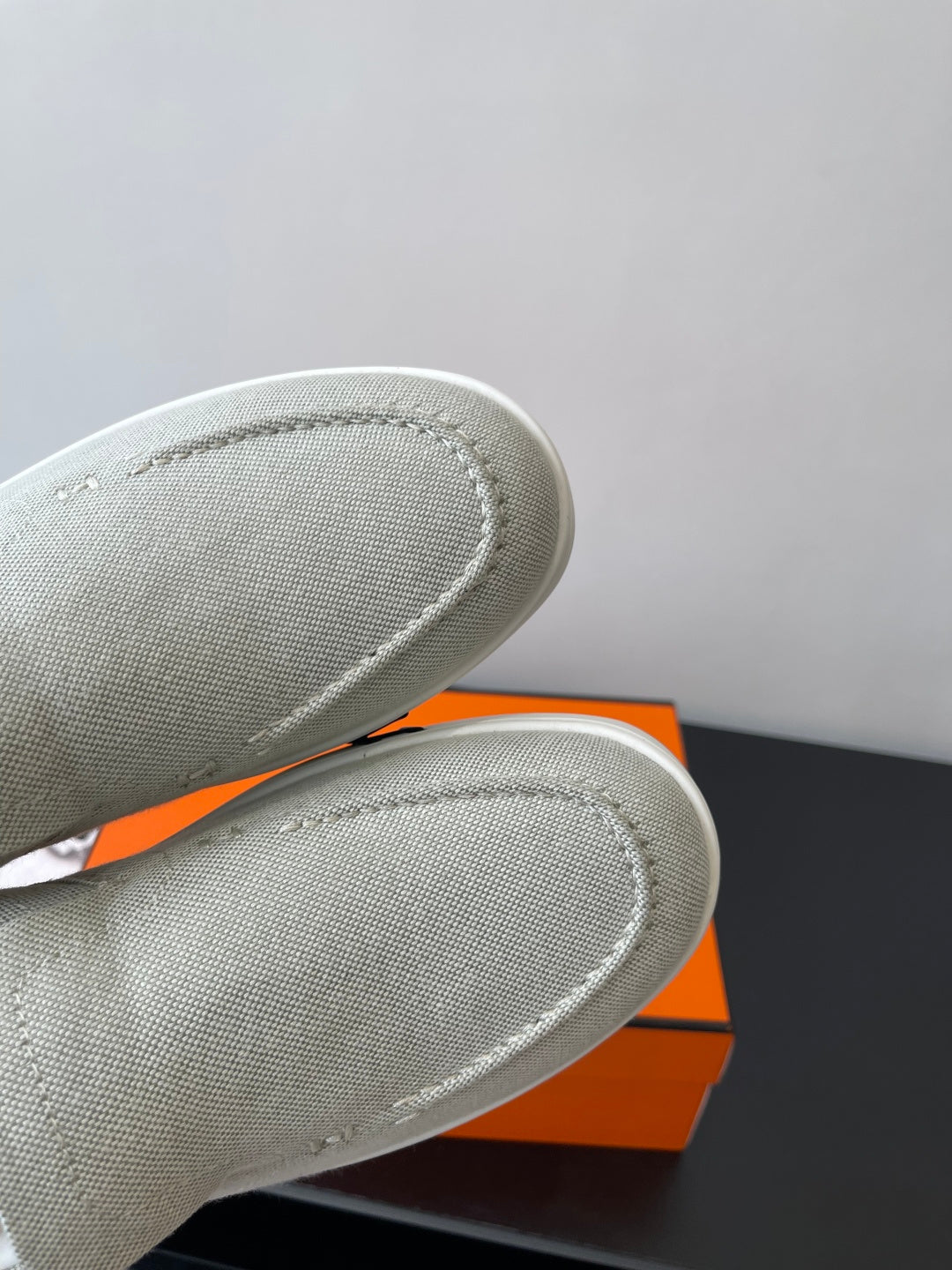 Hermes ladies light gray canvas slip-on sneakers, close-up textured fabric toe and seam