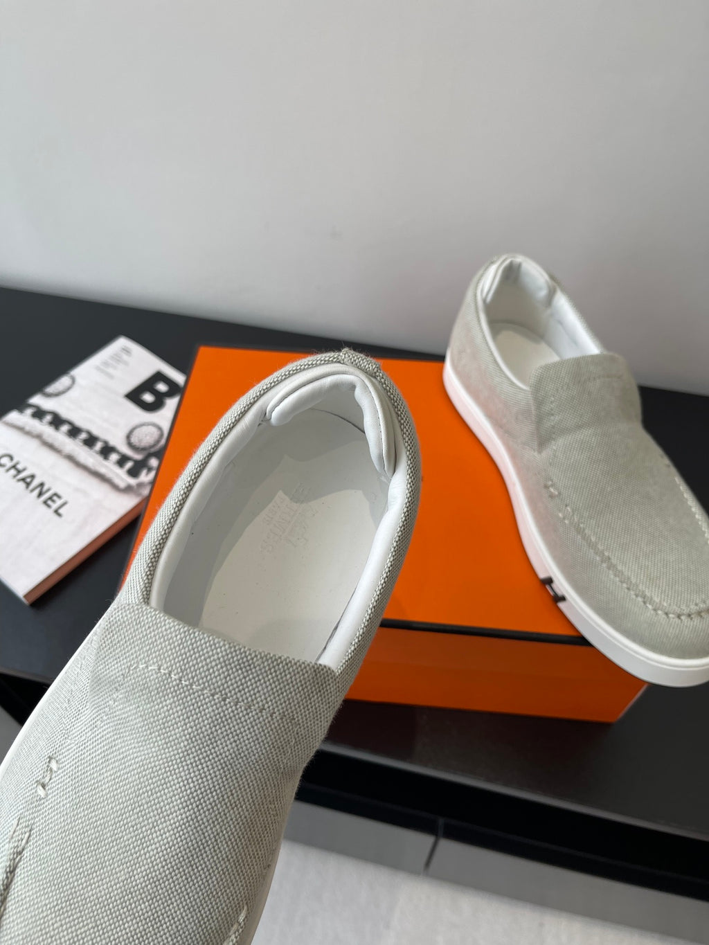Hermes ladies light gray canvas slip-on sneakers, interior lining visible, cushioned collar