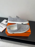 Hermes women’s gray suede slip-on sneakers, angled view with white outsole