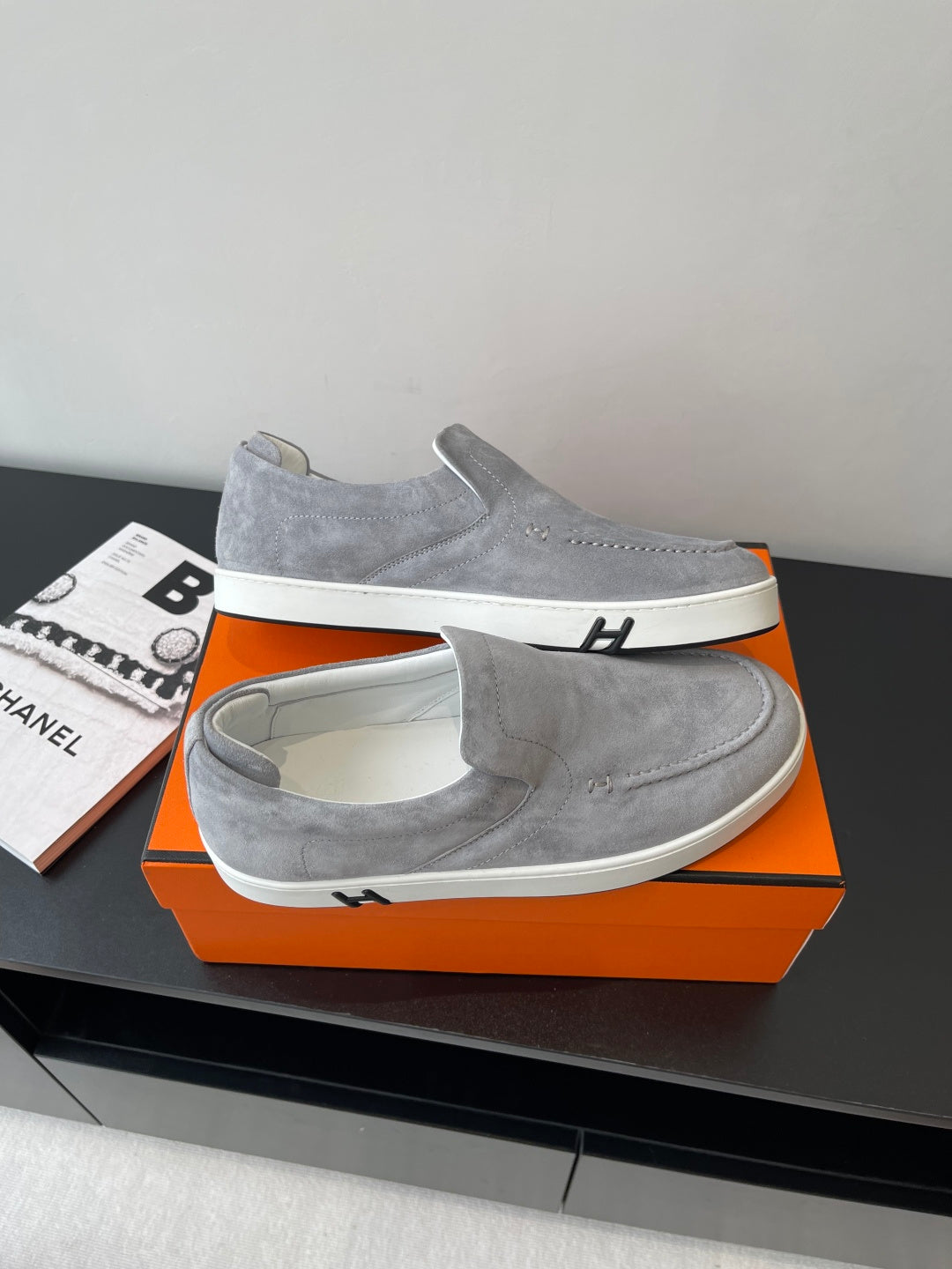 Hermes women’s gray suede slip-on sneakers, angled view with white outsole