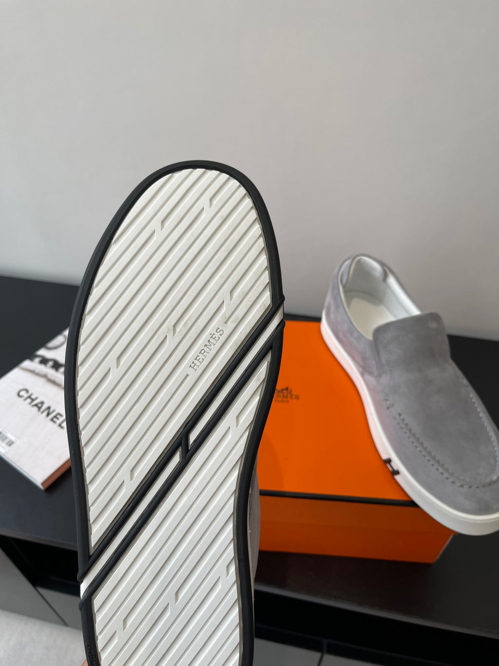Hermes women’s gray suede slip-on sneakers with visible tread outsole, heel and toe