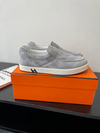 Hermes women’s gray suede slip-on sneakers with low profile and white sole