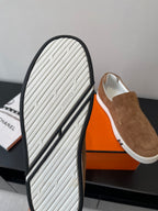 Hermes suede slip-on loafers outsole view, textured white tread and black edge