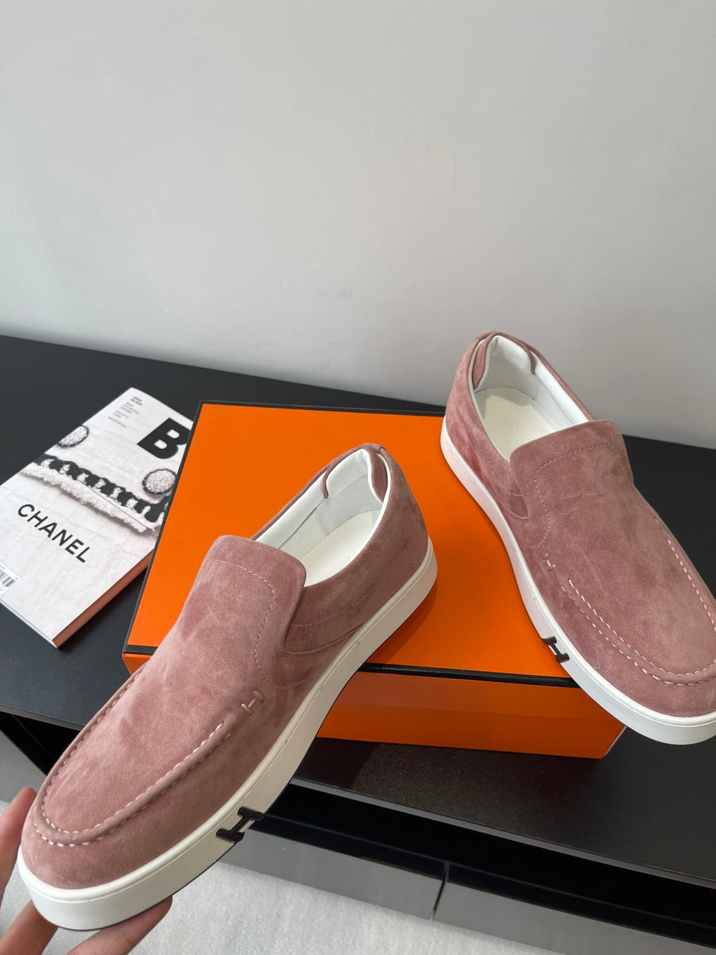 Women’s mauve suede loafers showing side profile, white sole, and decorative stitch
