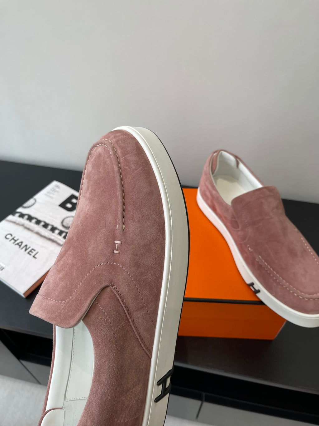 Women’s mauve suede loafers from side, showing white sole and small strap detail