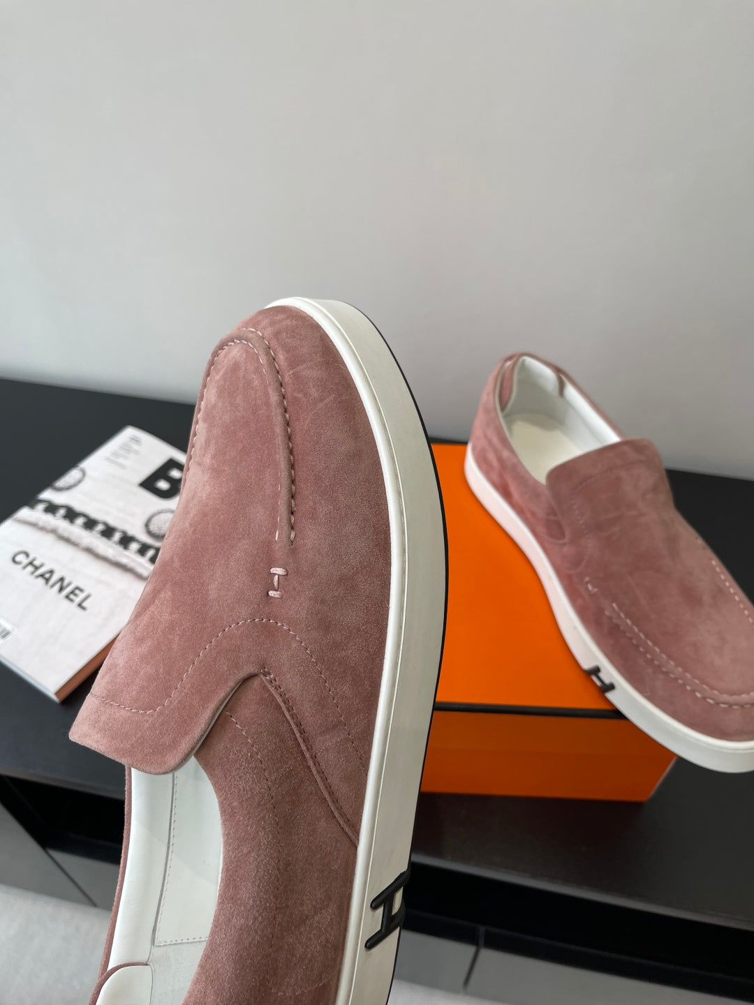 Women’s mauve suede loafers from side, showing white sole and small strap detail