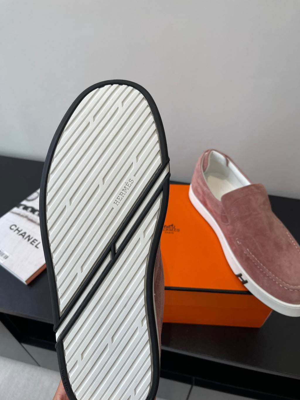 Mauve suede loafer sole view with white tread and black rubber border