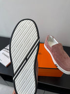Mauve suede loafer sole view with white tread and black rubber border