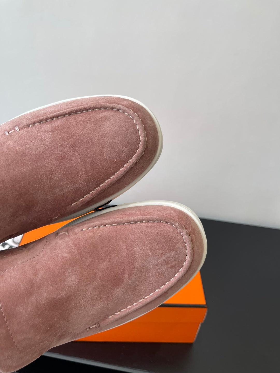 Close-up of mauve suede loafer vamp with contrast stitching and rounded toe