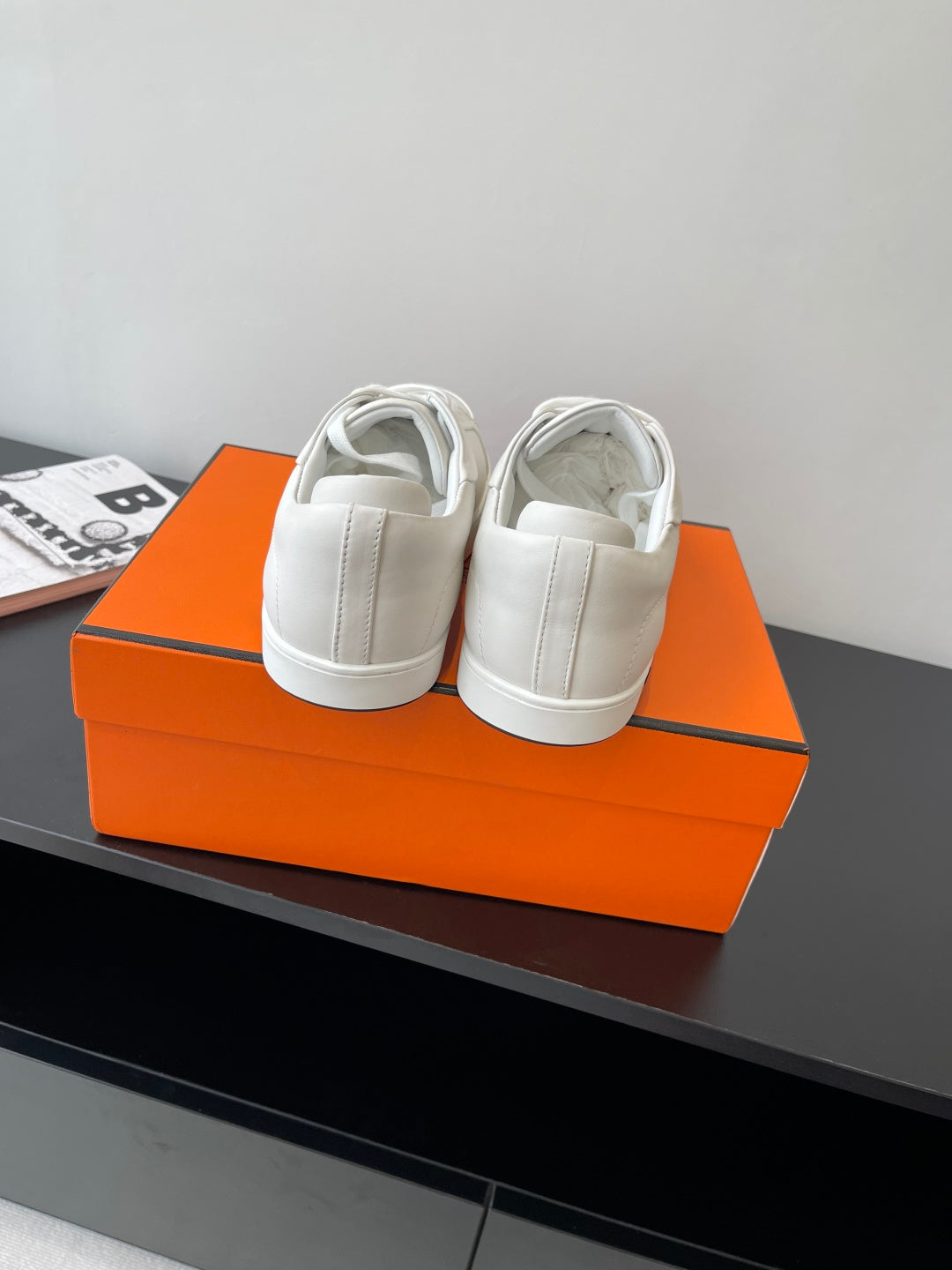 Hermes women’s white sneakers, heel view with padded collar and lace-up front