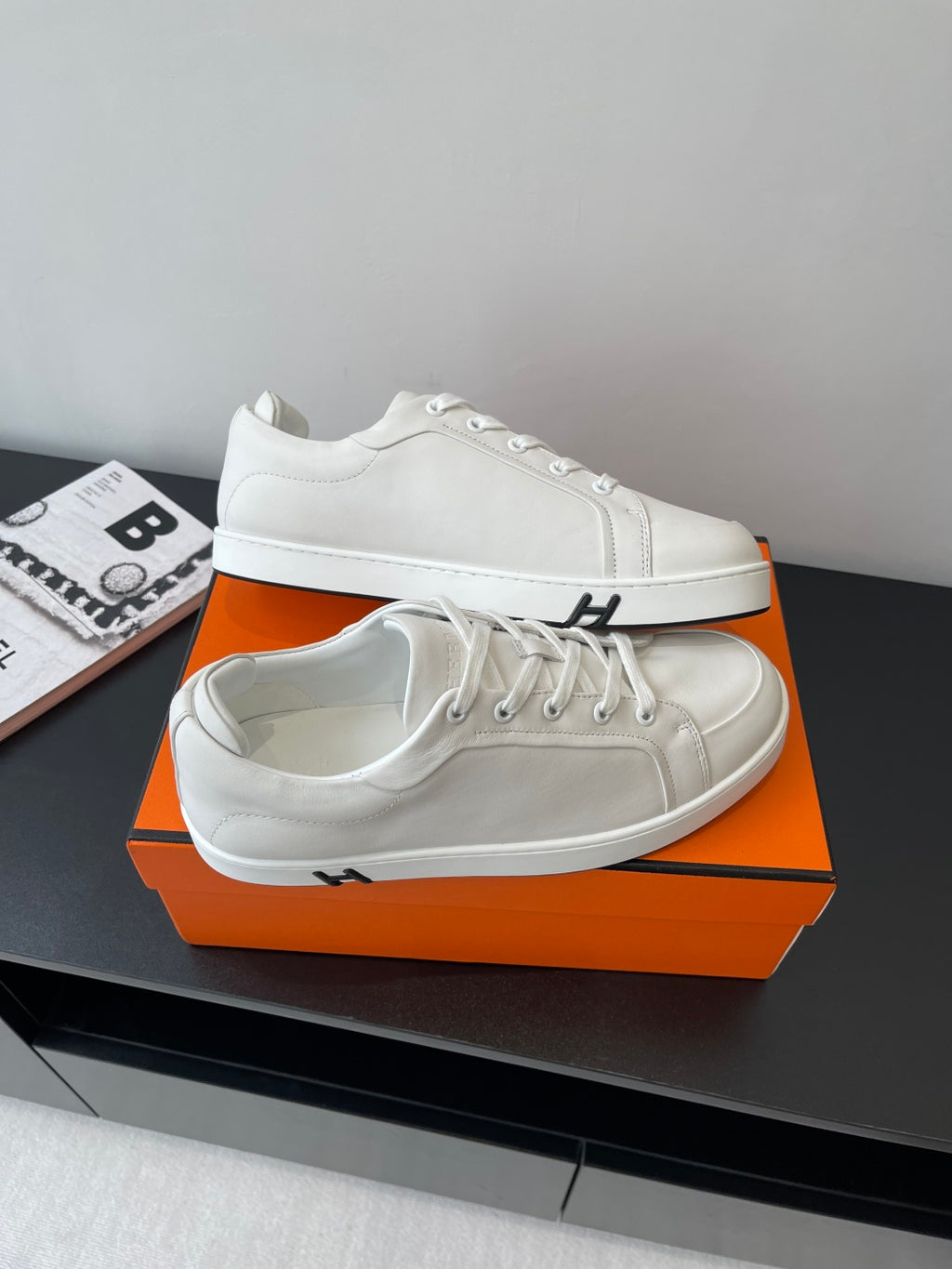 Hermes women’s white low-top sneakers, lace-up uppers with H stripe detail