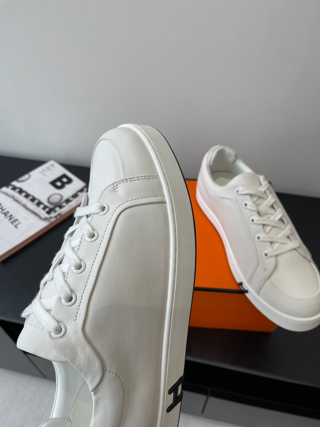 Hermes women’s white sneakers with smooth leather side panel and lace eyelets