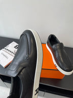 Black leather loafer with white sidewall sole and stitched upper seam