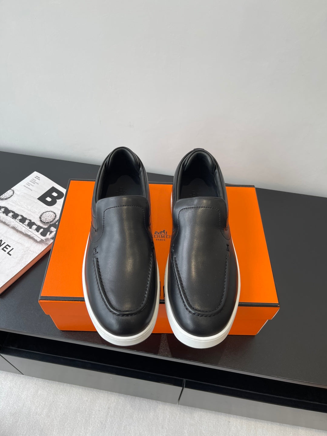 Black leather slip-on loafers with round toe and white rubber sole