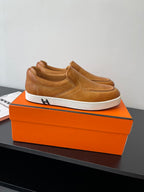 Brown suede or leather slip-on loafers with cushioned collar and white platform sole.