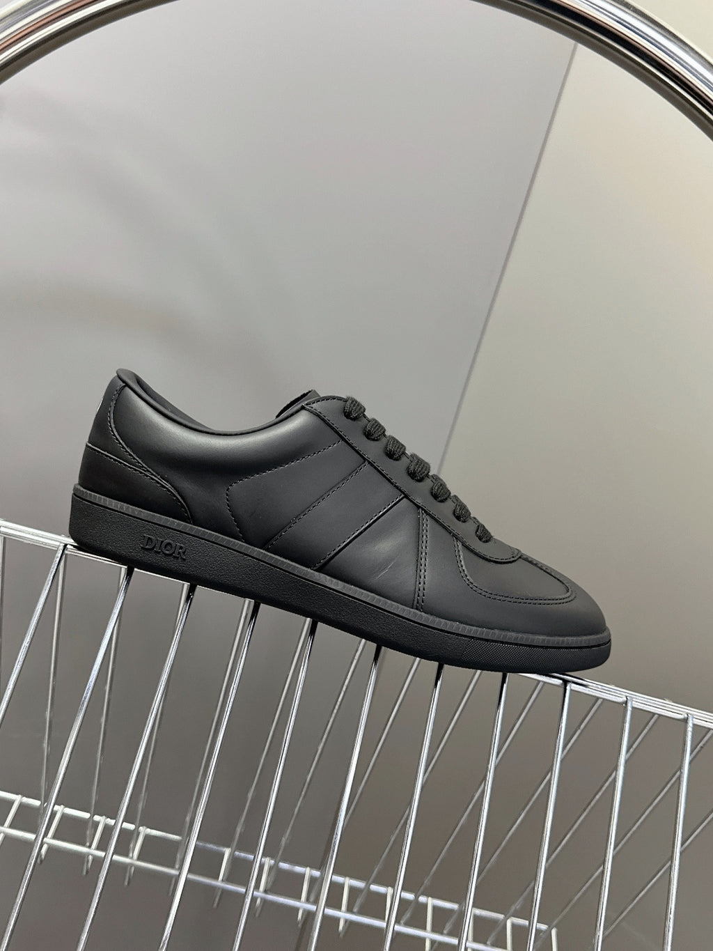 Black leather lace-up sneakers with low sole and smooth side panels