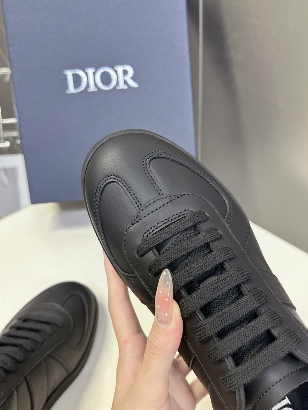 Black lace-up sneaker with Dior logo on the tongue and smooth leather upper