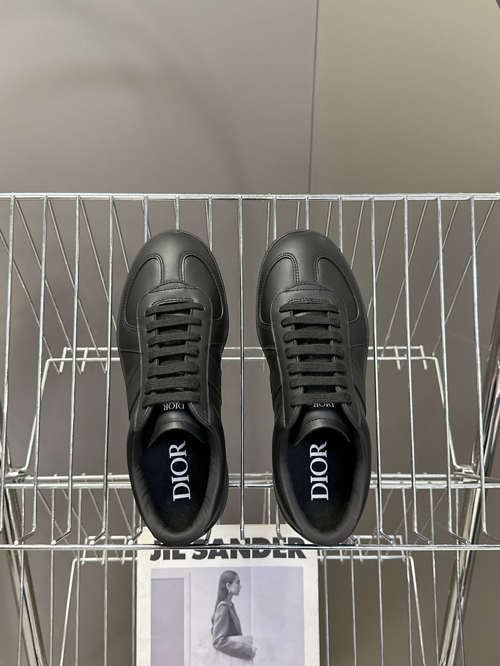 Black lace-up sneakers with Dior lettering on the inner lining